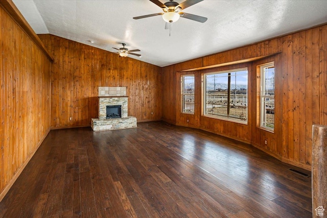 3356 W 1200 S, Ogden, UT 84404 - unfurnished living room with dark wood-style flooring, visible vents, lofted ceiling, ceiling fan, and wooden walls