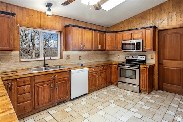 3356 W 1200 S, Ogden, UT 84404 - kitchen featuring a sink, brown cabinets, appliances with stainless steel finishes, and tasteful backsplash