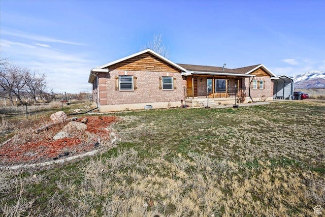 3356 W 1200 S, Ogden, UT 84404 - rear view of property with brick siding, covered porch, a yard, and a carport
