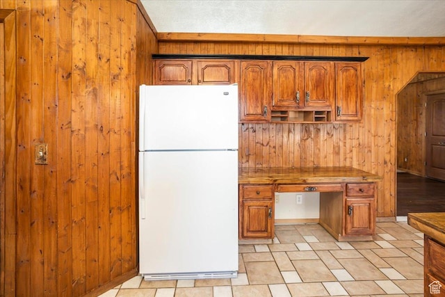 3356 W 1200 S, Ogden, UT 84404 - kitchen featuring wooden walls, freestanding refrigerator, built in desk, and brown cabinets