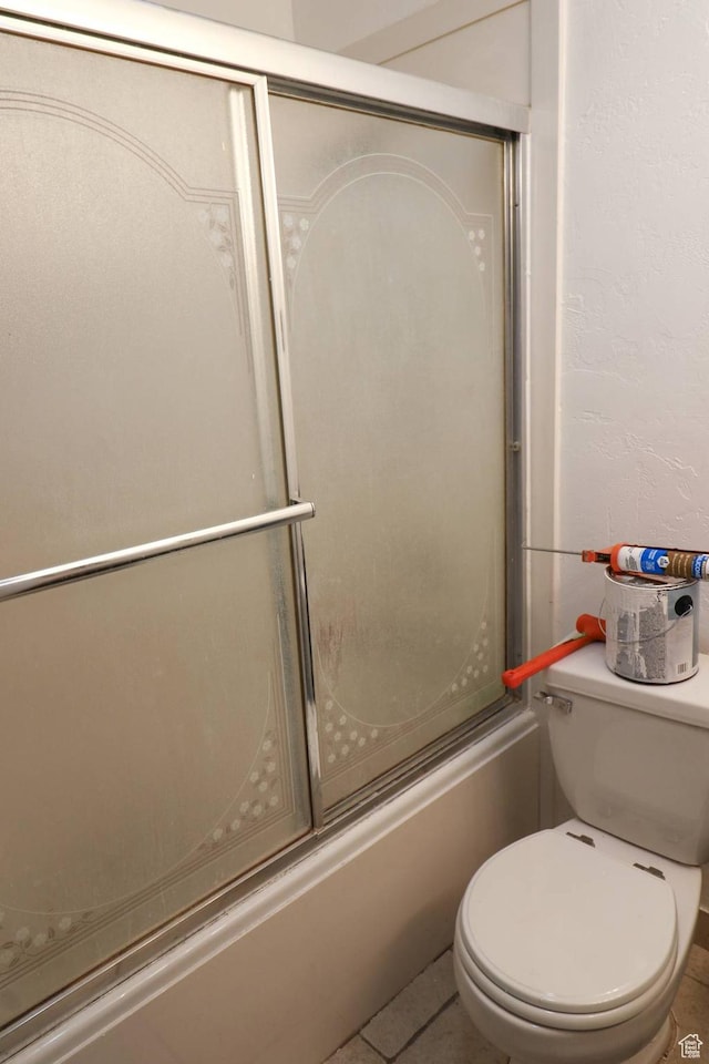 367 W 1100 N, Logan, UT 84341 - bathroom featuring combined bath / shower with glass door, toilet, and tile patterned floors