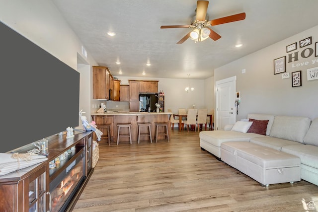 1128 S 820 E Unit 6104, Heber City, UT 84032 - living room featuring recessed lighting, light wood-style flooring, and ceiling fan with notable chandelier