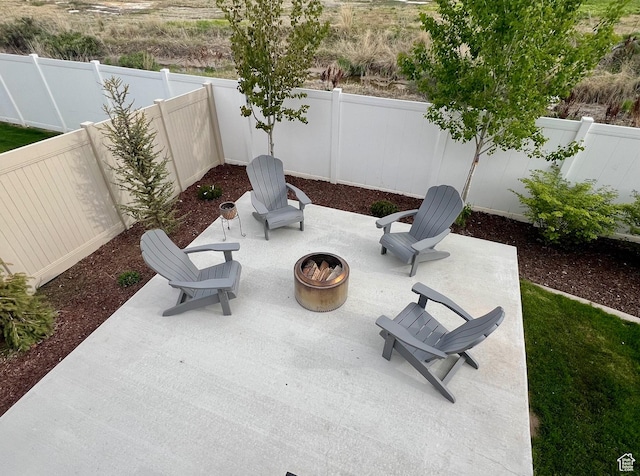 view of patio with an outdoor fire pit and a fenced backyard