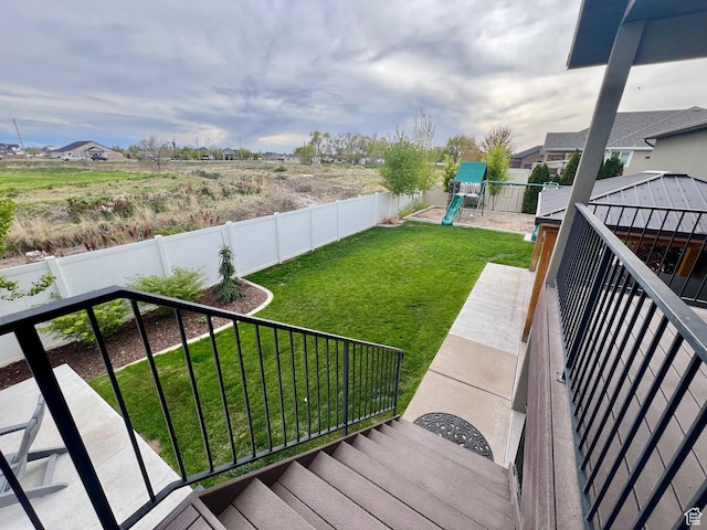 view of yard featuring a fenced backyard and a playground