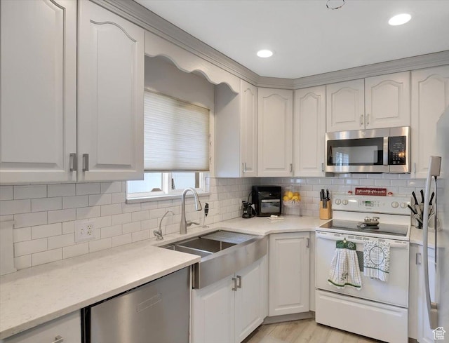 1564 N 1600 E, Logan, UT 84341 - kitchen with a sink, backsplash, appliances with stainless steel finishes, and white cabinetry