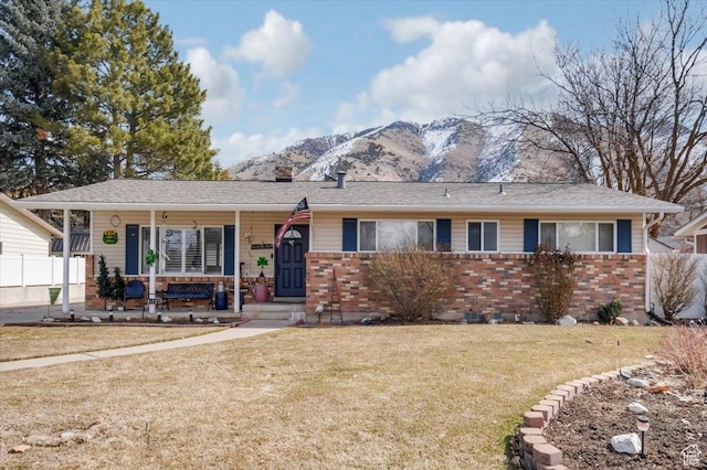 1564 N 1600 E, Logan, UT 84341 - ranch-style home with a front yard, a porch, brick siding, and a chimney