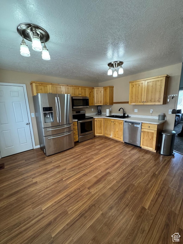 840 E 170 N, Heber City, UT 84032 - kitchen with stainless steel appliances, a sink, light countertops, dark wood-style floors, and a textured ceiling