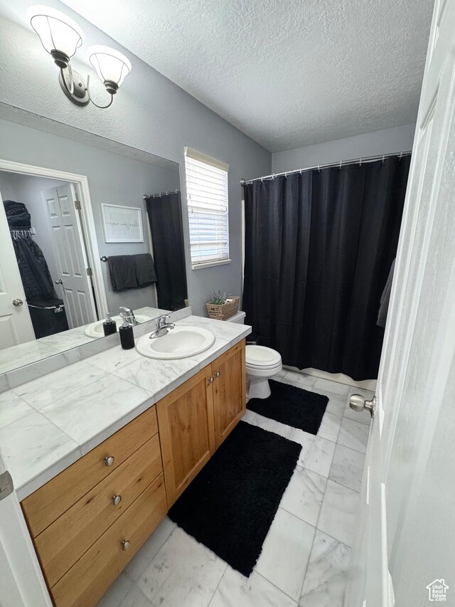 840 E 170 N, Heber City, UT 84032 - bathroom featuring a textured ceiling, marble look tile flooring, vanity, and toilet