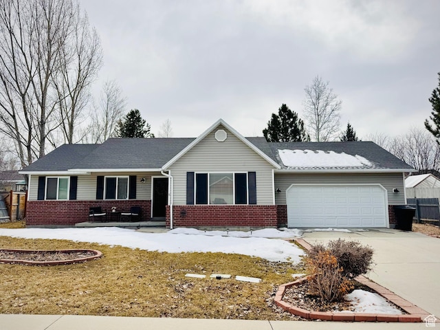 ranch-style house with concrete driveway, brick siding, and a garage