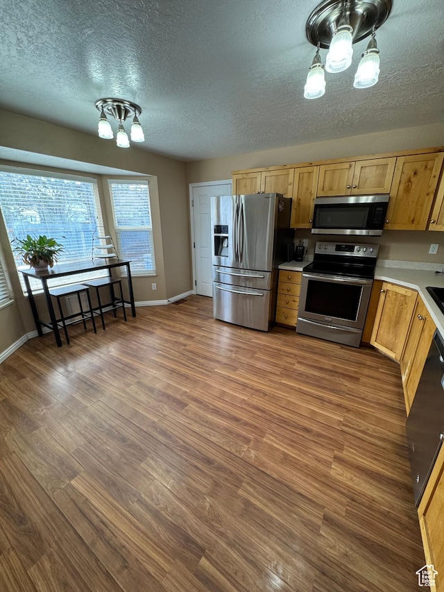 840 E 170 N, Heber City, UT 84032 - kitchen featuring stainless steel appliances, a chandelier, a textured ceiling, light countertops, and dark wood-style flooring