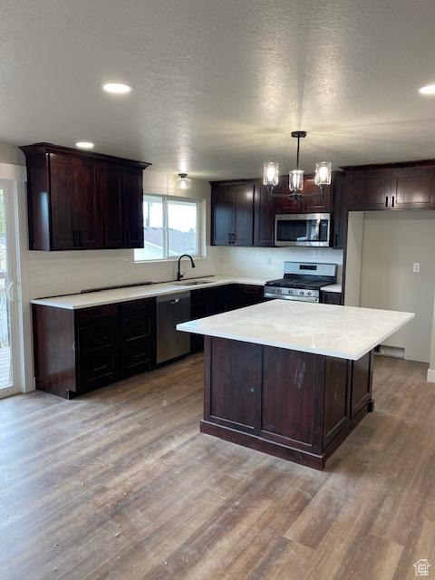 525 S 75 W, Providence, UT 84332 - kitchen with stainless steel appliances, a sink, light countertops, light wood finished floors, and recessed lighting