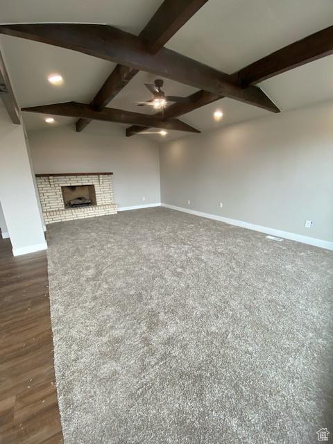525 S 75 W, Providence, UT 84332 - unfurnished living room with baseboards, beam ceiling, ceiling fan, recessed lighting, and a brick fireplace