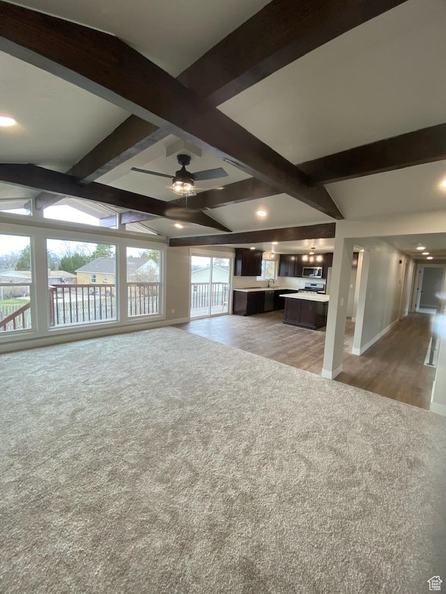 525 S 75 W, Providence, UT 84332 - unfurnished living room featuring baseboards, light colored carpet, ceiling fan, and vaulted ceiling with beams
