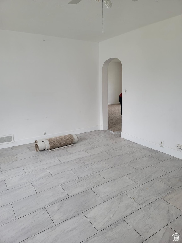 5949 W 5700 S, Hooper, UT 84315 - spare room featuring arched walkways, a ceiling fan, and baseboards