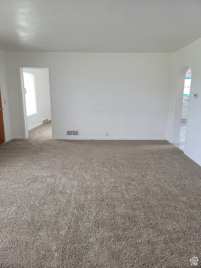 5949 W 5700 S, Hooper, UT 84315 - empty room with arched walkways, light carpet, and baseboards