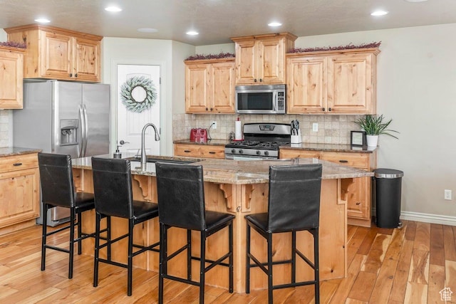 955 W 720 N, Tremonton, UT 84337 - kitchen with light brown cabinets, appliances with stainless steel finishes, and light wood finished floors