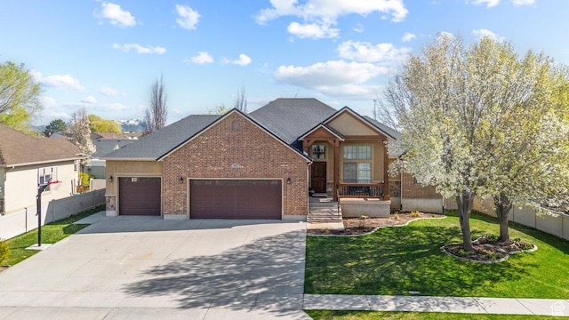 955 W 720 N, Tremonton, UT 84337 - traditional-style home featuring concrete driveway, an attached garage, fence, and a front lawn