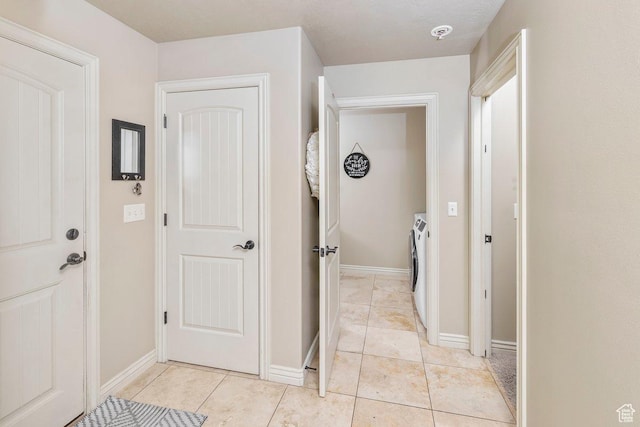 955 W 720 N, Tremonton, UT 84337 - hallway with light tile patterned flooring, baseboards, and washer and clothes dryer