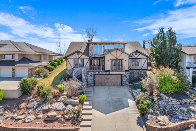 1060 E Summit Ridge Dr, St George, UT 84790 - tudor-style house featuring stucco siding, driveway, stone siding, a garage, and stairs