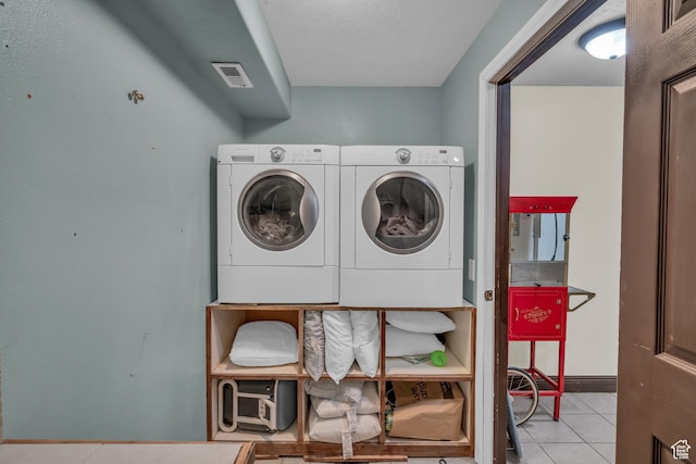 1060 E Summit Ridge Dr, St George, UT 84790 - washroom with visible vents, washer and clothes dryer, tile patterned flooring, baseboards, and laundry area