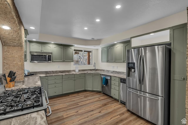 1060 E Summit Ridge Dr, St George, UT 84790 - kitchen with light wood finished floors, green cabinets, recessed lighting, appliances with stainless steel finishes, and a sink