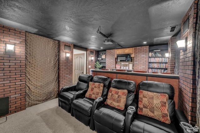 1060 E Summit Ridge Dr, St George, UT 84790 - home theater featuring visible vents, carpet floors, a textured ceiling, and brick wall