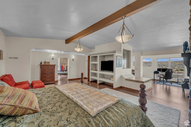 1060 E Summit Ridge Dr, St George, UT 84790 - bedroom with visible vents, vaulted ceiling with beams, baseboards, wood finished floors, and arched walkways