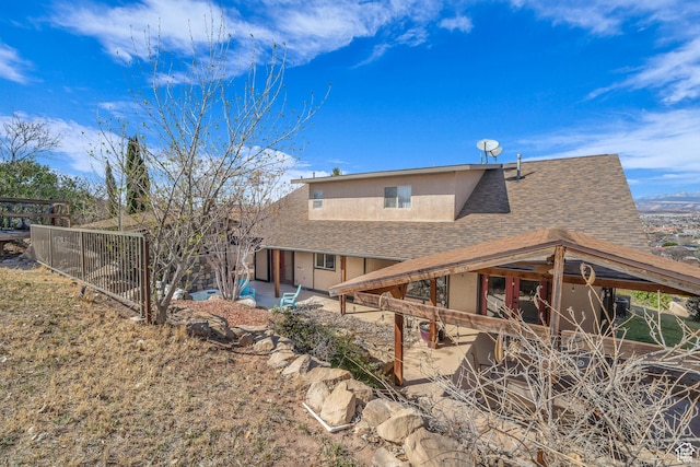 1060 E Summit Ridge Dr, St George, UT 84790 - back of property featuring stucco siding, a shingled roof, a patio, and fence