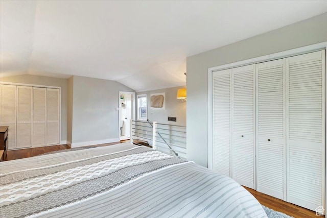 bedroom with a closet, wood finished floors, and vaulted ceiling