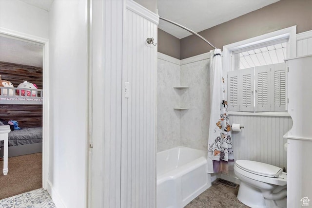 bathroom with tile patterned floors, toilet, and shower / tub combo