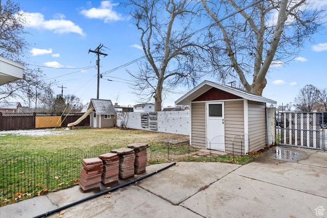 exterior space featuring an outbuilding, a storage unit, and a fenced backyard