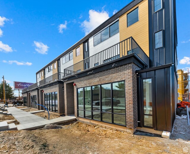 4386 S 900 E Unit 102, Millcreek, UT 84124 - rear view of property featuring a balcony and brick siding