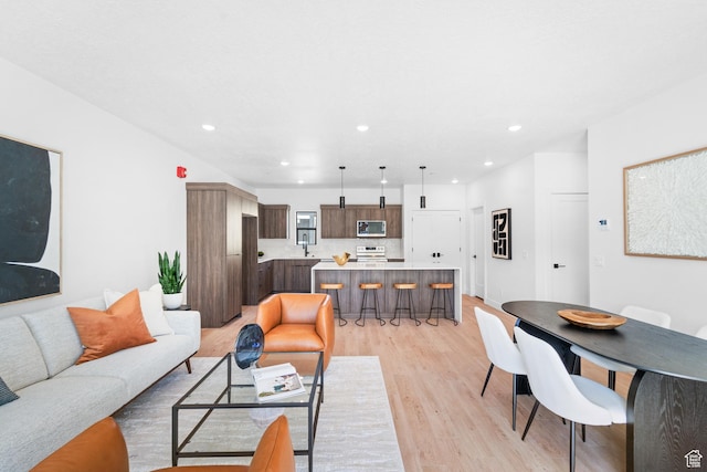 4386 S 900 E Unit 102, Millcreek, UT 84124 - living area featuring light wood-type flooring and recessed lighting