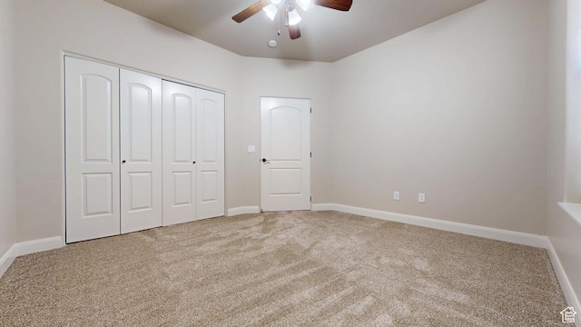 unfurnished bedroom featuring a closet, baseboards, carpet, and a ceiling fan