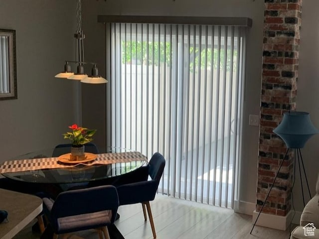 dining space with a wealth of natural light and light wood finished floors