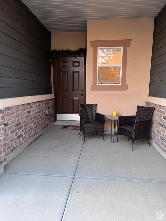 doorway to property featuring stucco siding