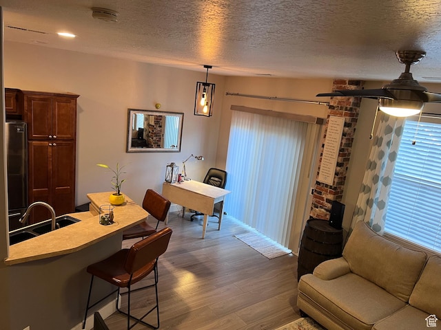 living room with wood finished floors and a textured ceiling