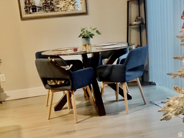 dining room featuring baseboards and wood finished floors