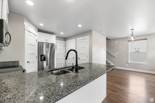 1848 E American Way Unit 2, Eagle Mountain, UT 84005 - kitchen with appliances with stainless steel finishes, a sink, baseboards, dark stone counters, and dark wood-style floors