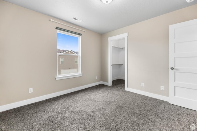 1848 E American Way Unit 2, Eagle Mountain, UT 84005 - unfurnished bedroom with baseboards, carpet flooring, and a spacious closet