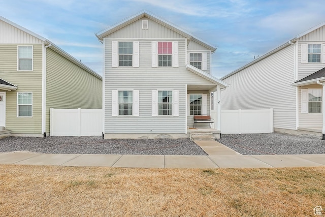 view of front of home with board and batten siding and fence