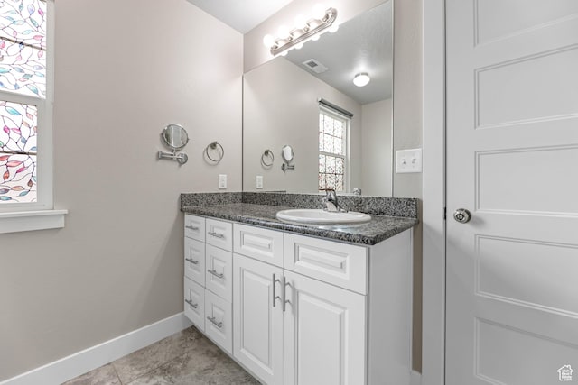 1848 E American Way Unit 2, Eagle Mountain, UT 84005 - bathroom featuring baseboards, vanity, and tile patterned floors