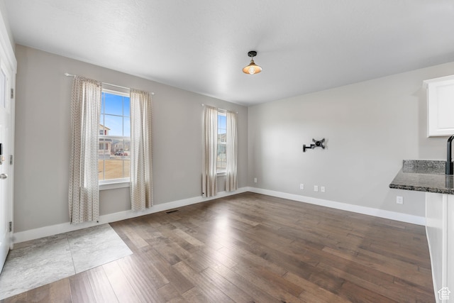 1848 E American Way Unit 2, Eagle Mountain, UT 84005 - unfurnished dining area featuring wood-type flooring and baseboards