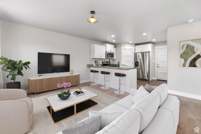 1848 E American Way Unit 2, Eagle Mountain, UT 84005 - living area featuring wood finished floors, recessed lighting, and baseboards
