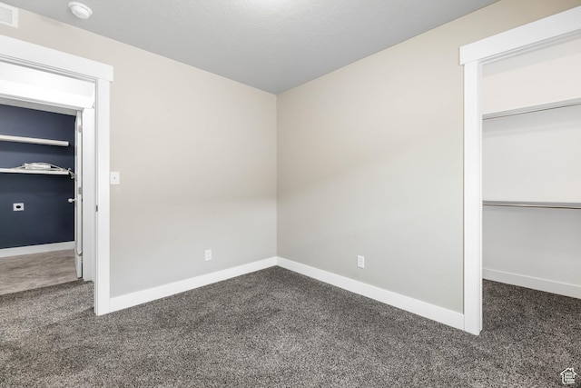 1848 E American Way Unit 2, Eagle Mountain, UT 84005 - unfurnished bedroom featuring dark colored carpet, baseboards, and a closet