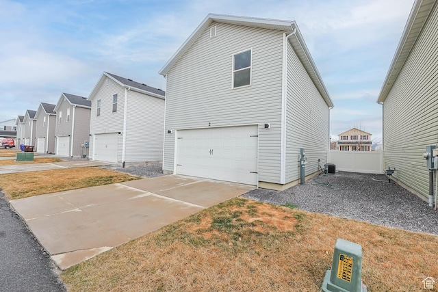 1848 E American Way Unit 2, Eagle Mountain, UT 84005 - view of side of home featuring a garage, driveway, fence, a residential view, and cooling unit