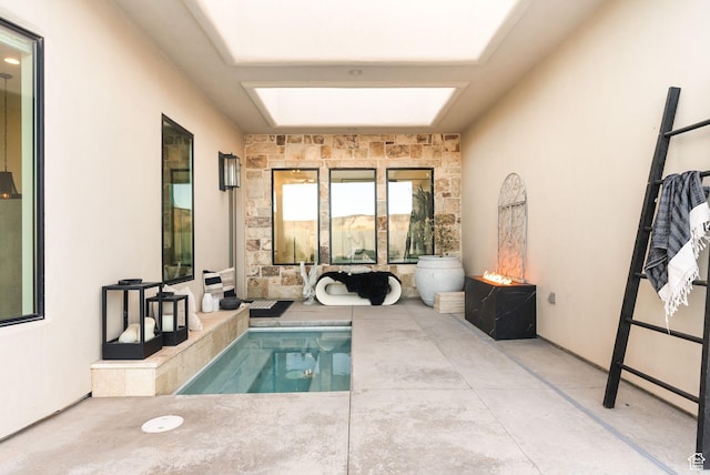 view of swimming pool featuring a skylight