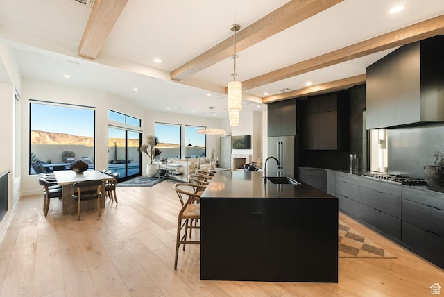 kitchen featuring dark countertops, beamed ceiling, modern cabinets, and dark cabinetry
