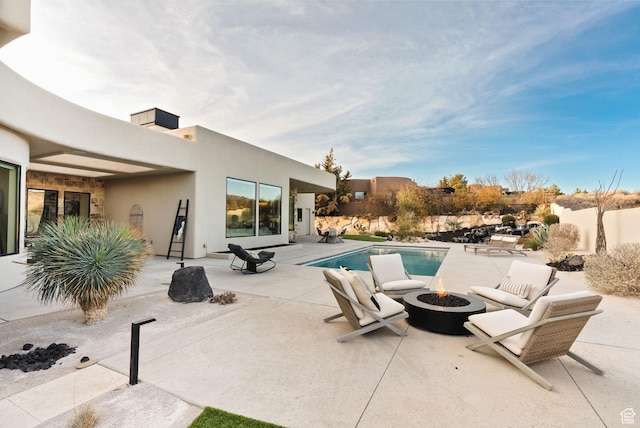 view of pool with a fenced in pool, an outdoor fire pit, and a patio