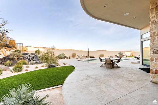 view of patio / terrace featuring a fenced in pool and fence